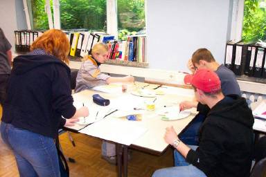 Hier werden die Gestaltungsvorschläge gerade hergestellt: Zeichnungen werden entsprechend den gestalterischen Absichten und Kundenwünschen farblich ausgelegt.